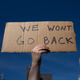 DETROIT, MI - JUNE 24: An abortion rights demonstrator raises a sign in the air during a protest of the Supreme Court’s decision in the Dobbs v Jackson Women’s Health case.